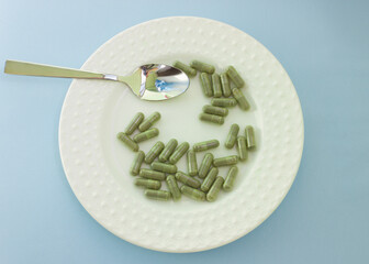 Chlorella in capsules super food. vegetable dietary Supplement Chlorella.the capsules are in the dish