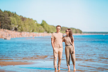 Young beautiful couple having fun on tropical seashore.