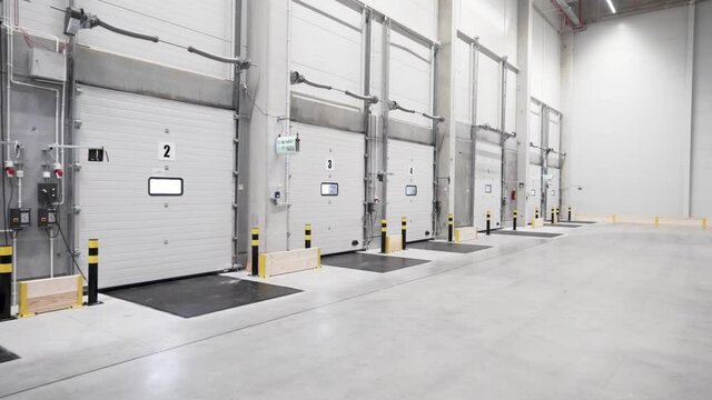Inside the warehouse, loading docks- clean empty logistic center 