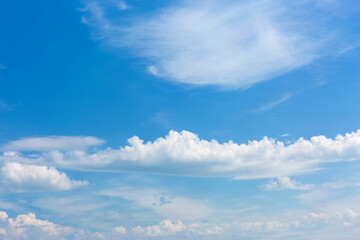 White clouds on blue sky background.