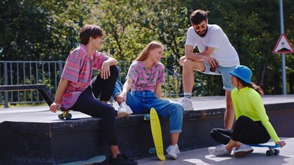 In the middle of urban skate park group of teen charismatic friends socializing together happy and smiling large concept of healthy lifestyle - Powered by Adobe