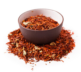 Rooibos tea in a ceramic bowl isolated on a white background.