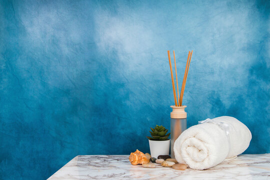 Spa objects and elements on a marble table and blue background
