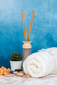 Spa objects and elements on a marble table and blue background