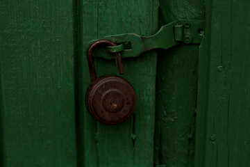 The old lock on the green door. Macro shooting of the lock on the green door