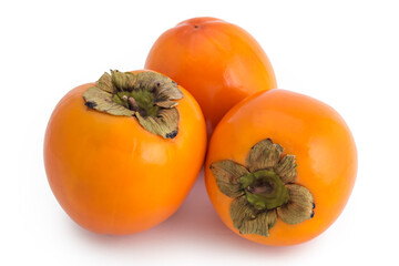 Three fresh raw persimmon fruit isolated on white background 