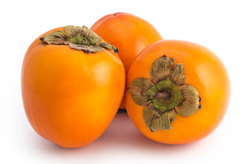 Three fresh raw persimmon fruit isolated on white background 