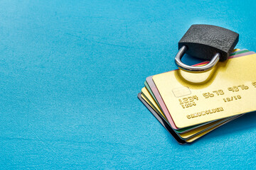 Credit card security concept with lock on blue desk copy space