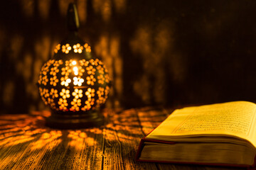 Holy Koran - Quran and rosary beads on the background with candle for Islamic concept. 