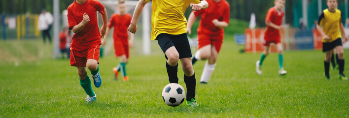 Soccer Players in Run. Young Boys Running After Ball During Football Tournament Match. Sports...