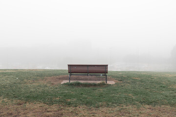 Empty bench with foggy scene.