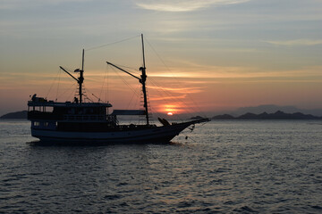Naklejka premium Fishing boat at sunset, Komodo Island, Labuan Bajo, East Nusa Tenggara, Indonesia