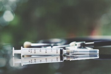 syringe and stethoscope on table