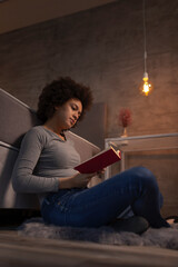 Woman reading a book at home