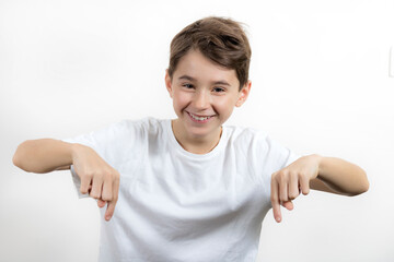 Teenage boy in white shirt. Portrait in studio. Funny faces.