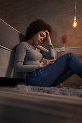 Fototapeta na wymiar Stressed out woman sitting by the bed at night