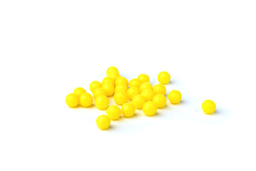 Yellow pills isolated on white background.