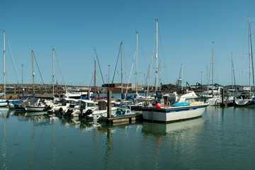 Fototapeta na wymiar View of Newhaven Marina view of boats and yachts at moorings on a warm and sunny summers day on the the South Coast of England.