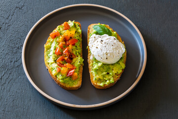 Tasty sandwich with poached egg, avocado and tomatoes