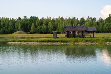 A small wooden house near the lake in a rural area