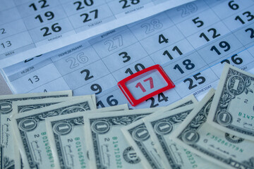 Banknotes of dollars on calendar sheets closeup