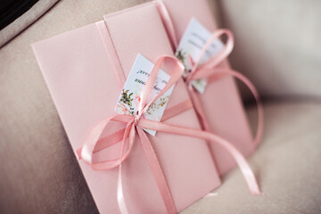 Pink gift certificate, envelope tied with a ribbon. Wedding invitation cards.