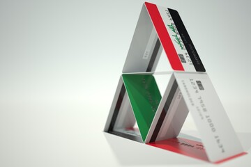 Flag of Iraq on plastic bank card house, fictional data. Financial instability related 3D rendering