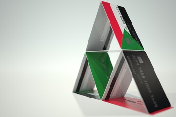 National flag of Sudan on bank card house, fictional data. Risky financial decisions related 3D rendering