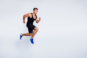 Fototapeta premium Full length body size view of his he nice attractive muscular focused purposeful guy jumping running jogging sprint distance isolated over light gray pastel color background
