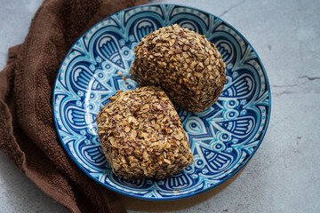 Bomboloni coated with oats. Donut filled with melted chocolate and eaten as a snack. Bomboloni originated from italy.