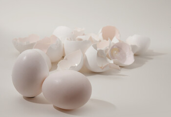 whole eggs and eggshells on a light background