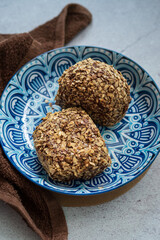 Bomboloni coated with oats. Donut filled with melted chocolate and eaten as a snack. Bomboloni originated from italy.