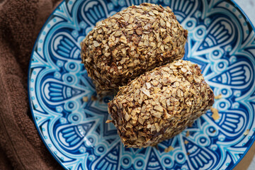 Bomboloni coated with oats. Donut filled with melted chocolate and eaten as a snack. Bomboloni originated from italy.