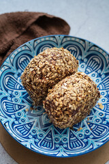 Bomboloni coated with oats. Donut filled with melted chocolate and eaten as a snack. Bomboloni originated from italy.