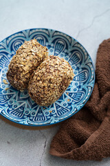 Bomboloni coated with oats. Donut filled with melted chocolate and eaten as a snack. Bomboloni originated from italy.