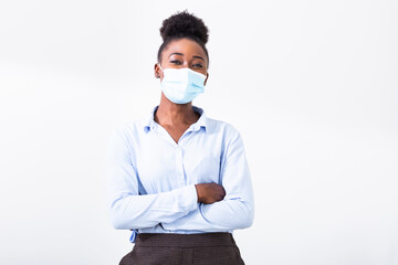 Studio portrait of young business woman wearing a face mask, looking at camera, close up, isolated on gray background. Flu epidemic, dust allergy, protection against virus. City air pollution concept