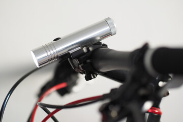 Close-up view. LED Flashlight on Bike Handlebar.