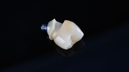 dental crown made of ceramics and connection with the abutment from zercon, shot on a black background