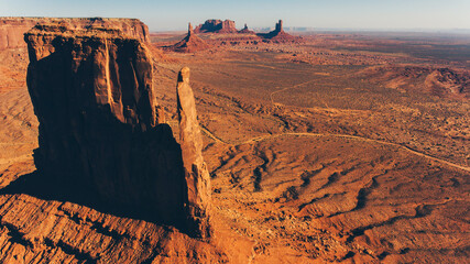 Bird's eye scenery view of unique geological formation of Arizona landmark. Monument Valley rocks one of the National symbols of the United States of America. Sandy desert landscape with roads