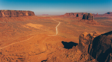 Bird's eye scenery view of unique geological formation of Arizona landmark. Monument Valley rocks one of the National symbols of the United States of America. Sandy desert landscape with roads