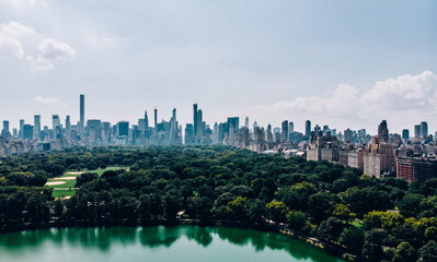 Fototapeta premium Aerial view from helicopter sightseeing tour around Central Park and Manhattan skyscrapers. Scenery view of eco architecture in big New York megapolis. Preservation of nature and care of environment