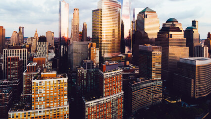 Aerial view from helicopter sightseeing tour around Manhattan Island.Scenery skyline with contemporary skyscrapers of downtown financial district in New York.Cityscape metropolis with reflected sunset