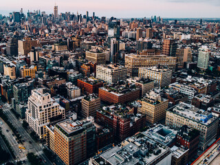 Aerial view from helicopter sightseeing tour around Manhattan downtown district. Scenery bird's eye view with blocks of buildings leaving horizon. Metropolis with developed city urban infrastructure