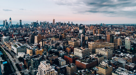 Aerial view from helicopter sightseeing tour around Manhattan downtown district. Scenery bird's eye view with blocks of buildings leaving horizon. Metropolis with developed city urban infrastructure