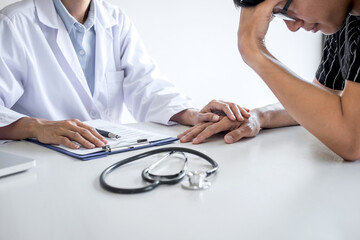 Doctor touching patient hand for encouragement and empathy in the hospital