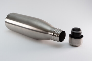 Metal flask, bottle for preservation of a hot or cold liquid on a white background.