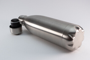 Metal flask, bottle for preservation of a hot or cold liquid on a white background.