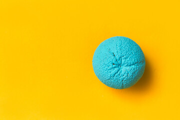 painted orange in cyan color on a yellow background. creative design concept