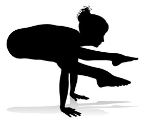 A silhouette of a woman in a yoga or pilates pose