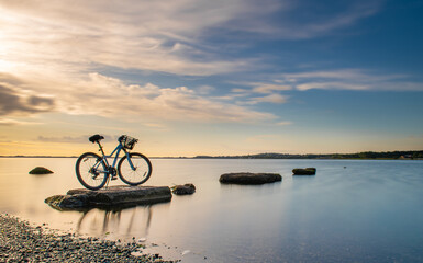 bicycle on the beach at sunset